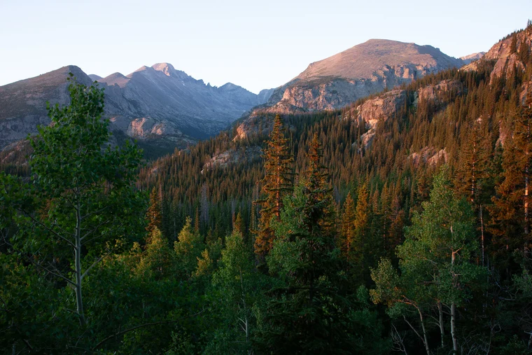 Original unedited frame of an autumn mountain scene, warm distant light already pulling the eye straight to the back.